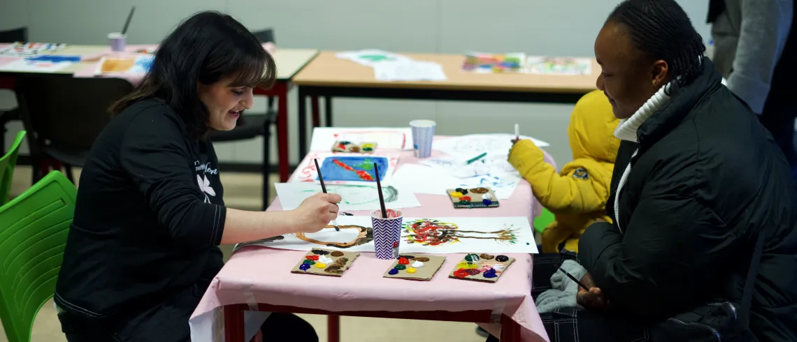 Deux femmes face à face réalisant des peintures